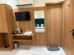 a room with a bed and a television in a room at Hotel Divya Regency in Jāmb