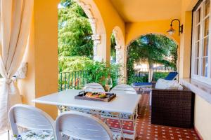 a white table and chairs on a patio at Residenza Le Logge in Torri del Benaco