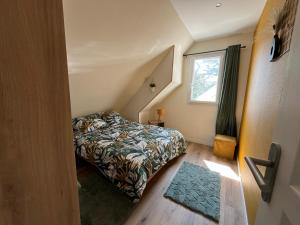 a small bedroom with a bed and a window at Arlega in Saint-Germain-sur-Ay