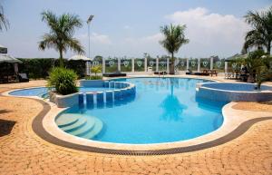 a large pool with blue water in a resort at Tatu City Serene 2BR Apartment in Tatu City