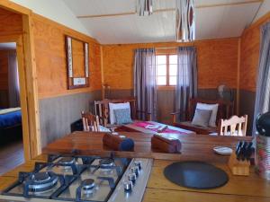 a kitchen with a table and a stove top at Faith Cabin in Waterval-Onder