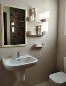 a bathroom with a sink and a toilet and a mirror at Magic golden pyramids view in Cairo