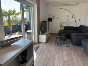 a living room with a couch and a table at Einmaliger Ausblick und tolles Ambiente in Laubenheim