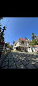 a large white building on the side of a street at Ocean Pearl Resort in Varkala