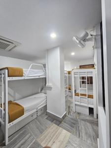 a bunk bed room with two bunk beds at Lowfare Dormitory in Kozhikode +15 photos