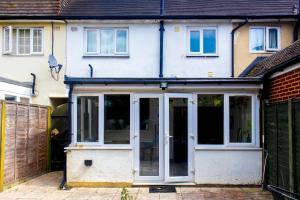 an extension to a house with sliding glass doors at Stunning Family Home nr London Harry Potter Tour Pass The Keys in Borehamwood