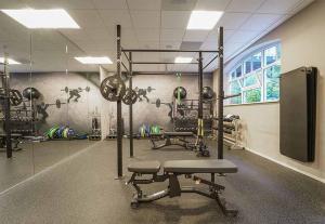 a fitness room with a gym with weights at Hotel Ter Zand - Handwritten Collection in Burgh Haamstede