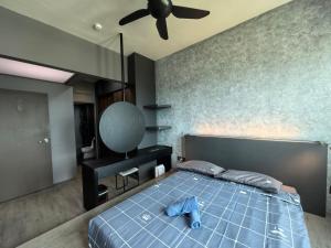 a bedroom with a blue bed with a ceiling fan at Meritus Relax Holiday Homestay in Perai +56 photos