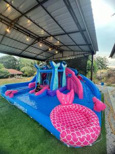 a inflatable water park with a person in the middle at AA SWEET ROOM TANJUNG BIDARA MELAKA in Masjid Tanah