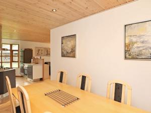 a dining room with a table and a kitchen at 8 person holiday home in Læsø in Læsø