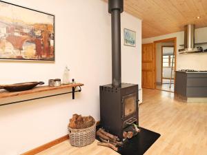 a wood stove in a living room with a wall at 8 person holiday home in Læsø in Læsø