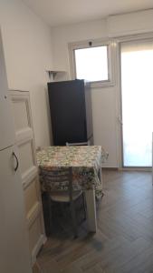 a room with a table and a chair and a window at Casa Vacanze Giada in Reggio Calabria