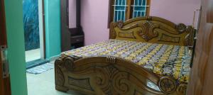 a bed with a wooden frame in a room at AR Residency in Kallār +7 photos