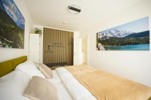 a bedroom with a bed with a large picture on the wall at VARIO-HAUS Residence in Theresienfeld