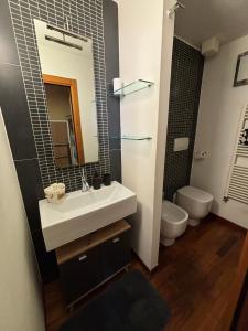 a bathroom with a sink and a toilet at Sweet Home Sweet Wine in Lastra a Signa