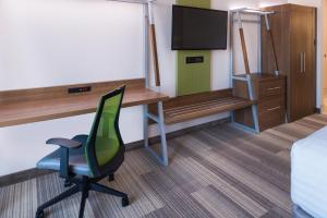 a room with a desk and a chair and a television at Holiday Inn Express Fort Worth West by IHG in Fort Worth