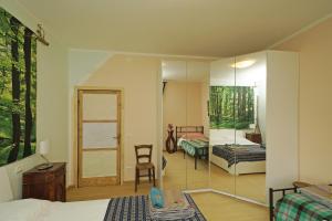 a room with a mirror and a bedroom with a bed at La Casa degli Artisti in Gardone Riviera