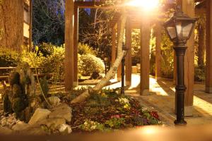 a garden with a street light and a tree at Ardboyne Hotel in Navan