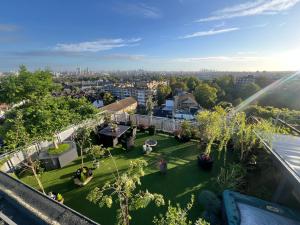 an aerial view of a garden with people on a lawn at The London Skyline Penthouse in London