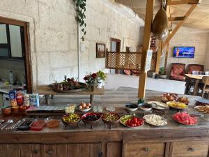 a table with many different types of food on it at Asma Altı Cave in Nar