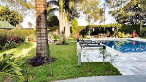 a group of benches sitting next to a swimming pool at Uyoga Villas in Arusha