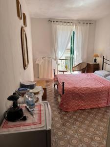 a bedroom with a bed with a red bedspread at Residence Della Corte in Tocco da Casauria