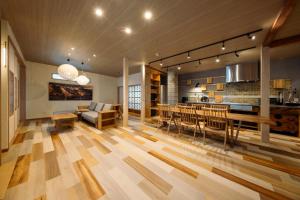 a living room with a kitchen and a dining room at Retaruke-レタルケ- in Biei