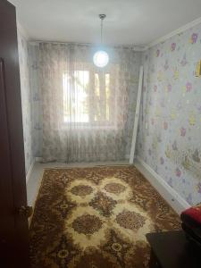 a room with a rug on the floor with a window at Karakol City Center in Karakol