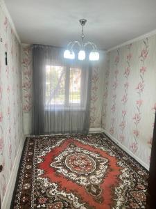 a room with a large rug on the floor at Karakol City Center in Karakol