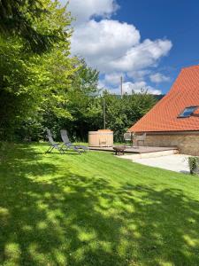 a green yard with a bench and a picnic table at La Borbiatte in Montavon