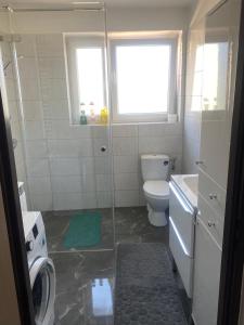 a bathroom with a shower and a toilet and a sink at Pokoje na wynajem "Pod Lasem" in Balice +29 photos