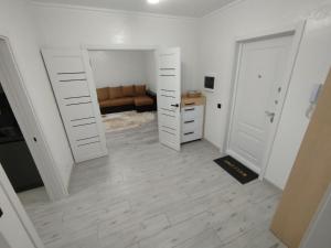 a room with two white doors and a couch at Comfort MD in Chişinău