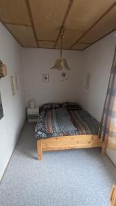 a bedroom with a wooden bed in a room at Gästehaus Bergstraße Hammermühle in Bad Düben