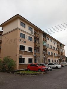 a red car parked in front of a building at Teratak RIZQ Kota Samarahan in Kota Samarahan