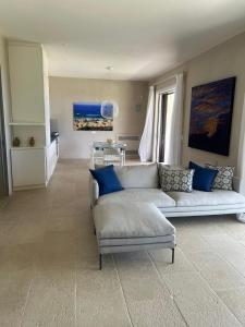 a living room with a couch and a table at Villa Heron Sicily in Noto +16 photos