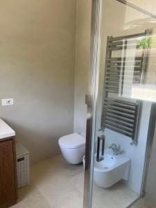 a bathroom with a toilet and a sink at Villa Heron Sicily in Noto