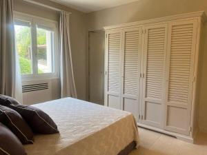 a bedroom with a bed and a large window at Villa Heron Sicily in Noto