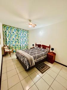 a bedroom with a zebra print bed and a ceiling fan at Coastal Bliss Retreat Peacehaven - Pool and Braai - 2 Adults 2 Children in Scottburgh