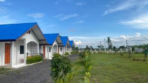 a row of houses with blue roofs at Route652 Resort Singburi in In Buri