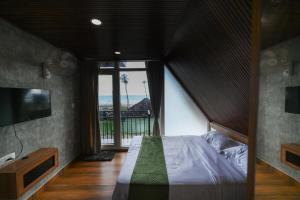 a bedroom with a large bed and a large window at Vadanapilly Beach Villa for 8-10 adults in Irimbranallūr
