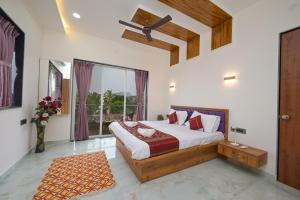 a bedroom with a bed and a large window at Shrirang Villa in Lonavala