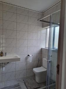 a bathroom with a toilet and a sink at Baytul Aafiyah in Gqeberha