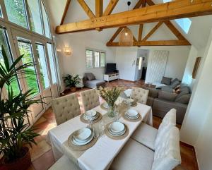 a living room with a table and a couch at Le Chalet du Parc - Maison de charme Proche Paris in Saint-Gratien