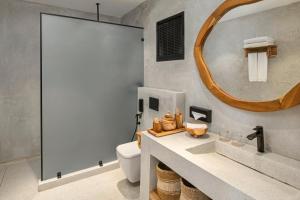 a bathroom with a sink and a mirror at Aldiana Club Zanzibar Kwanza in Kizimkazi
