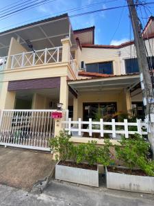 a house with a white fence in front of it at Kata beach Townhouse BL2 in Kata Beach