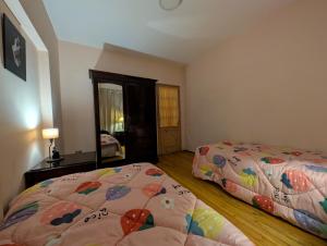 a bedroom with two beds and a mirror at Tango Violin in Cairo