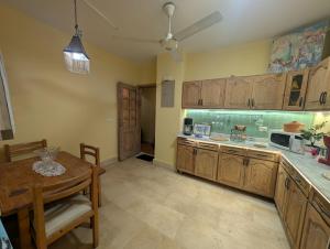 a kitchen with wooden cabinets and a table and a dining room at Tango Violin in Cairo