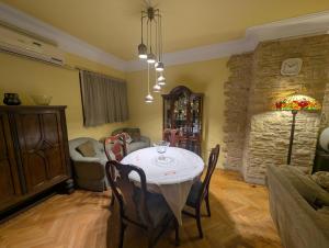 a dining room with a white table and chairs at Tango Violin in Cairo +42 photos