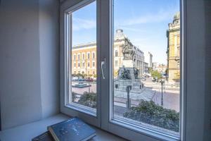 a window with a view of a city at Plac Matejki Apartments by Noah in Kraków