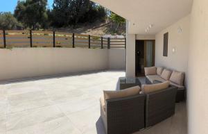 a patio with a couch and chairs on a patio at ΝΕΑΚΙΤΟΣ Luxury Apartments in Nikiti